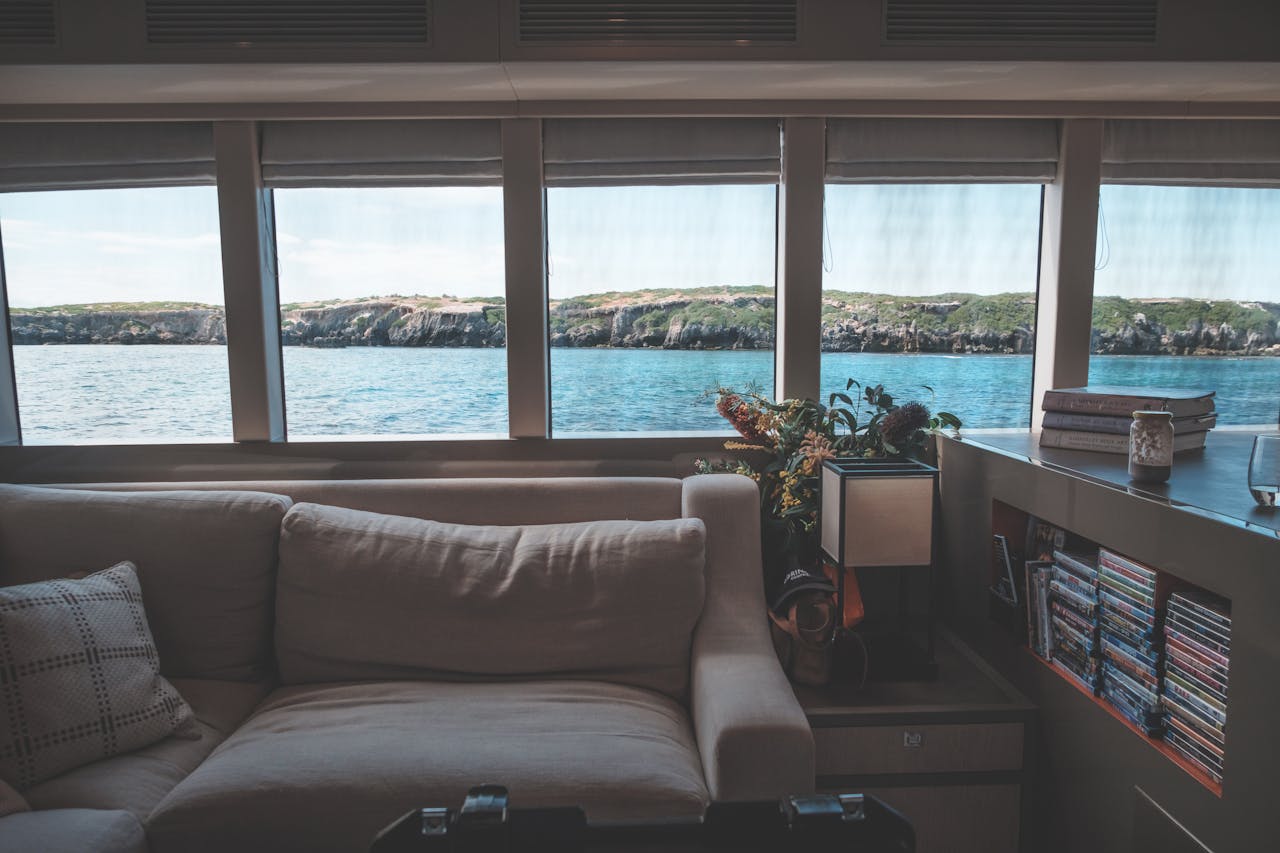 Elegant yacht interior with ocean view and cozy seating, perfect for a luxurious maritime escape.