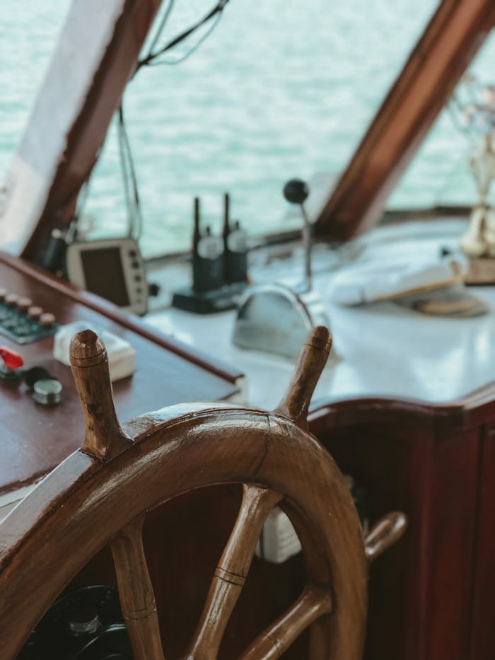 Wooden wheel and navigation tools in a vintage yacht in Turkey.